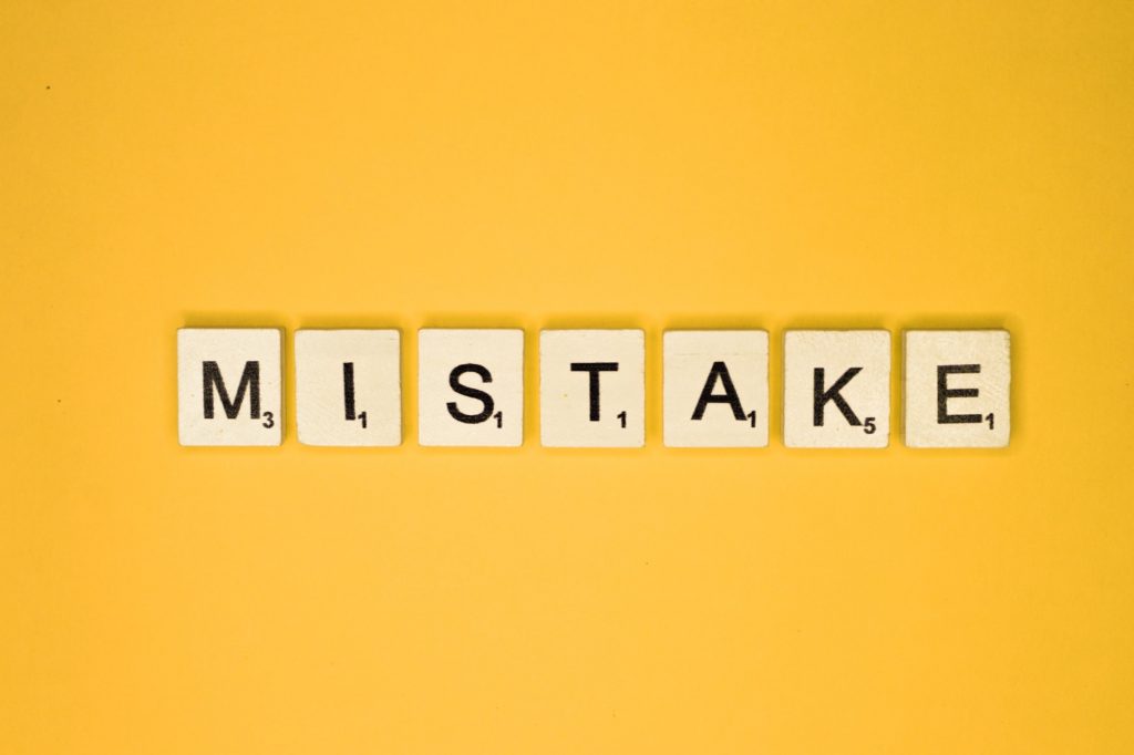 Letters spelling out the word mistake representing the top medicare mistakes people make.